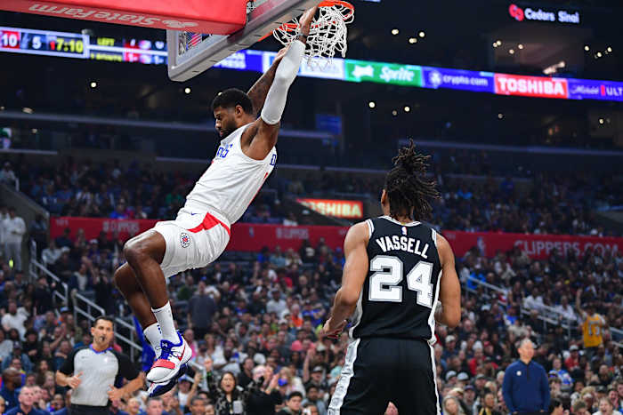 Oct 29, 2023; Los Angeles, California, USA; Los Angeles Clippers forward Paul George (13) dunks for the basket ahead of San Antonio Spurs guard Devin Vassell (24) during the first half at Crypto.com Arena.